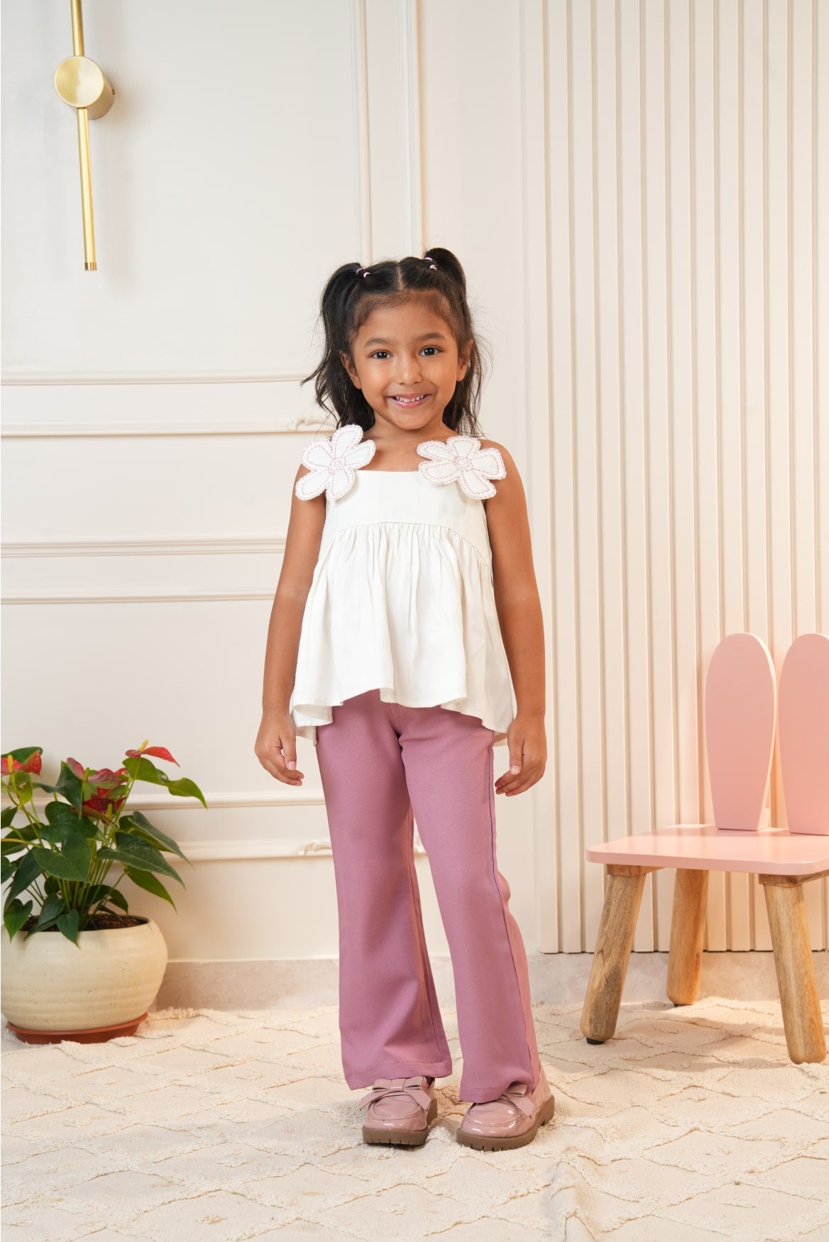 White strap top with pink flared pants