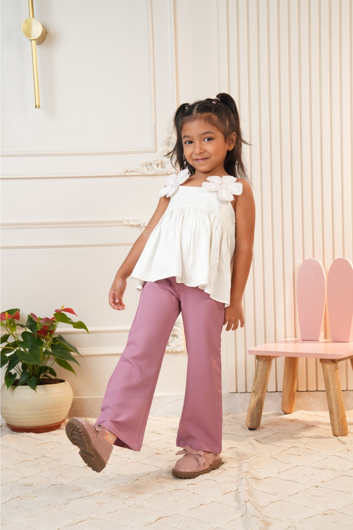 White strap top with pink flared pants