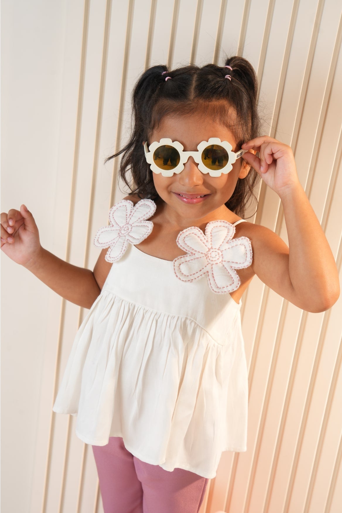 White strap top with pink flared pants