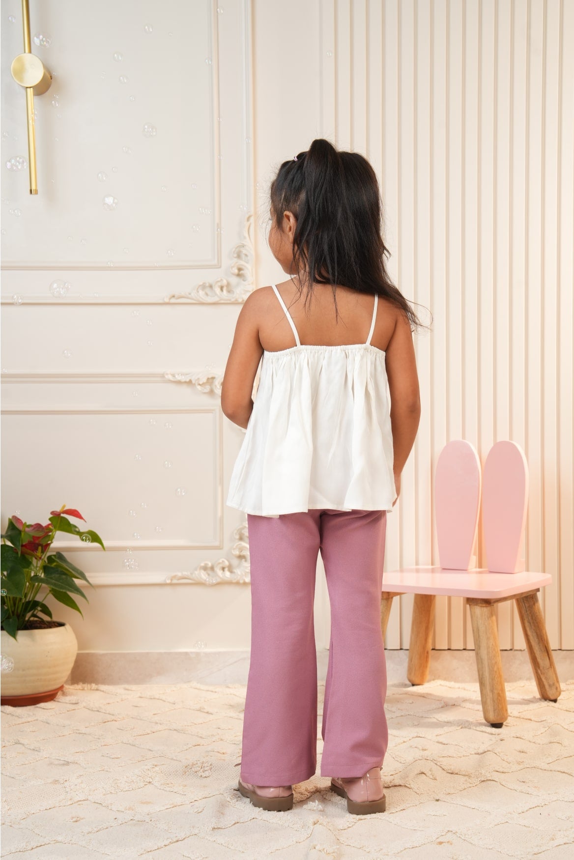 White strap top with pink flared pants